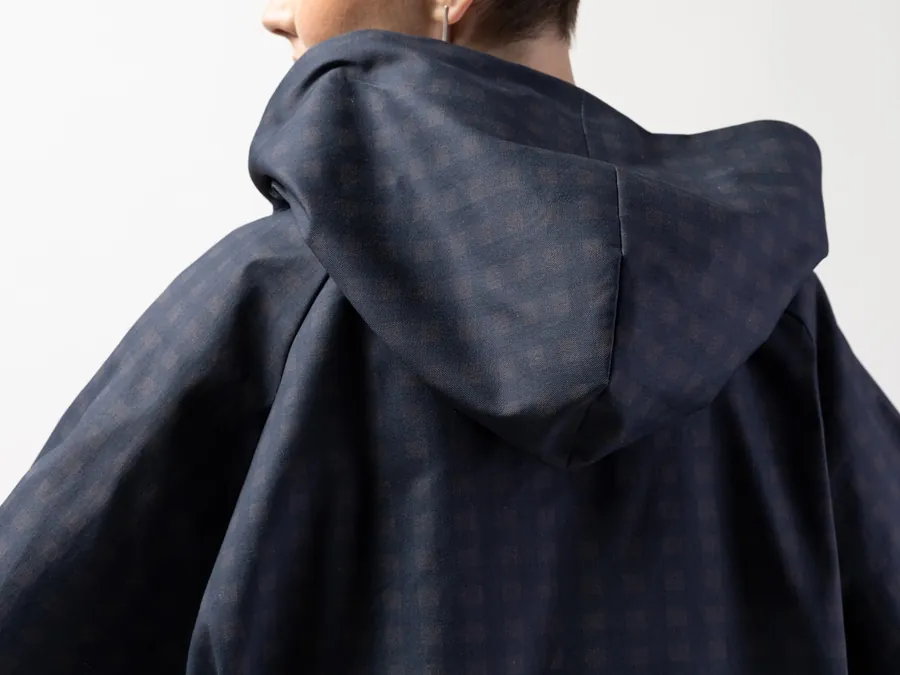 Outerwear sample detail showing hood scale, seam placement and fabric behaviour